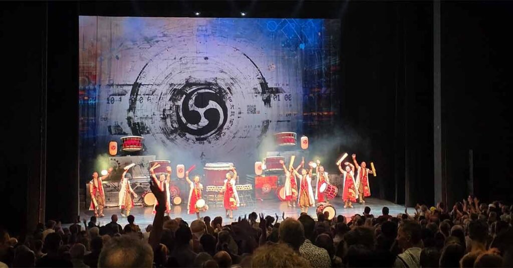 Yamato Drummers Basel performing live on stage with audience standing and applauding